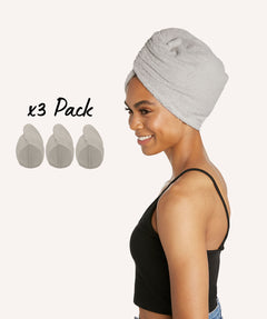Woman wearing cotton Turbie twist in oatmeal color. Text reads 3 Pack