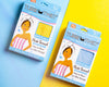 Two cotton hair towels in packaging laying side-by-side. One is yellow, one is blue.