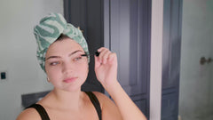 Video of women applying makeup and getting ready wearing a 100% cotton Turbie Twist Hair Towel in assorted animal prints.